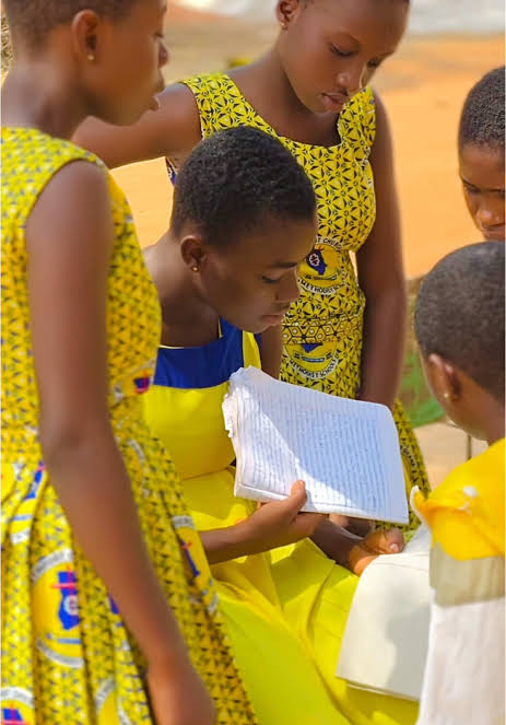 Tabere Methodist Junior High School students reading from a notebook